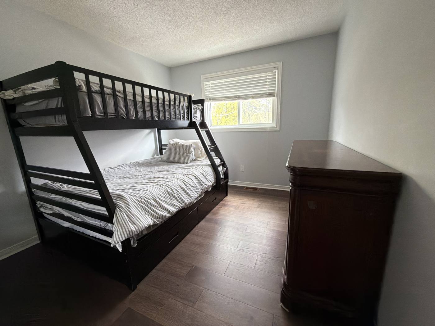 Bunk bedroom with a double bed below and a single above