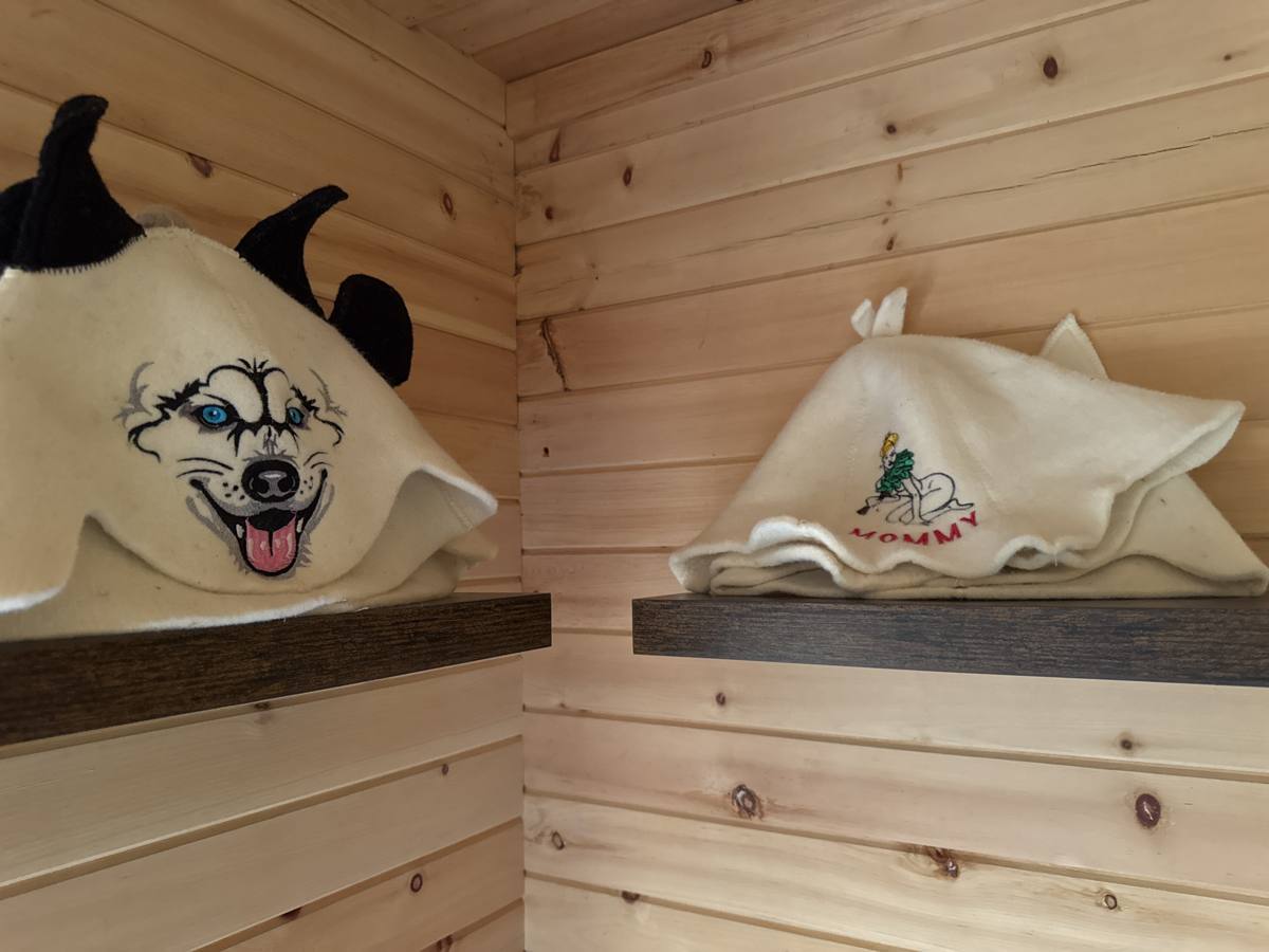 Felt sauna hats hanging inside the sauna